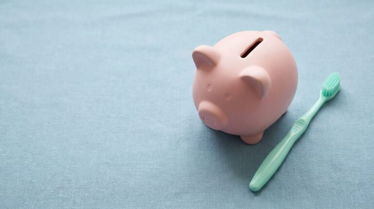 Piggy bank and toothbrush on a blue background