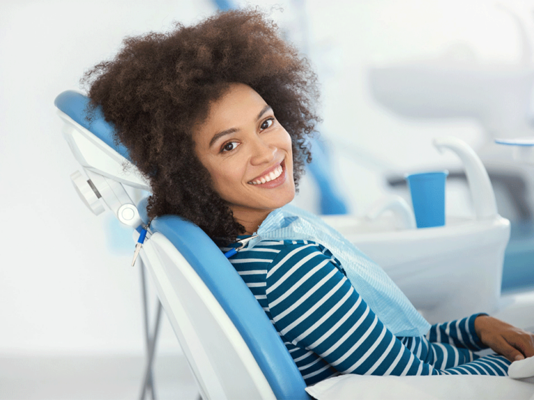 Female dental patient smiling in the chair